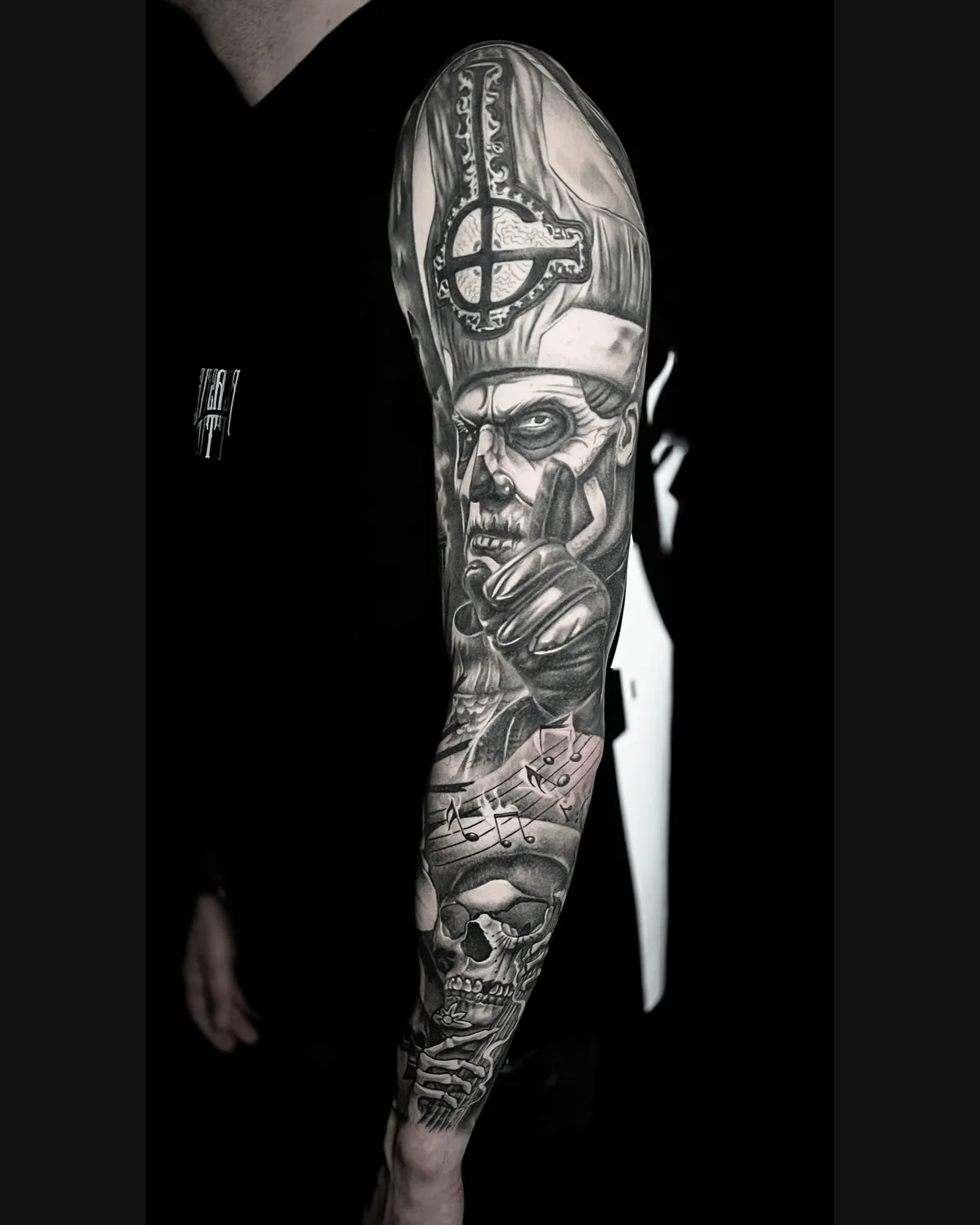 Full sleeve: skeleton pope, cross, skull and sheet music, black & grey, healed